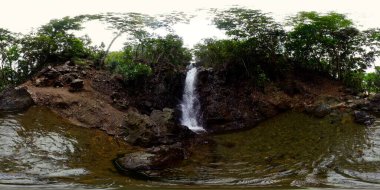 Diquisit Falls in green forest. Waterfall in the tropical mountain jungle. VR 360. Philippines. clipart