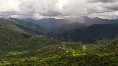 Mountains with green forests and agricultural land with farm plantations. Philippines.