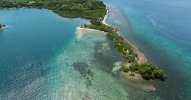 Shore of the island with the beach and blue sea.Turtle Islands, Negros, Philippines