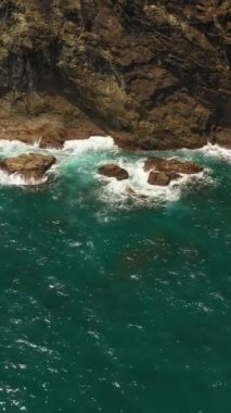 Aerial view of ocean waves crash on the rocky shore. Seascape. Philippines