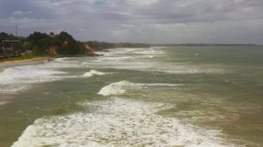 Wide sandy beach and ocean surf. Matara beach, Sri Lanka.