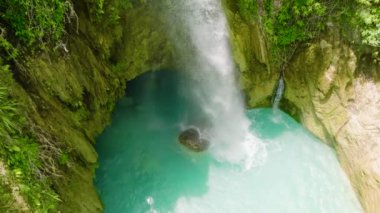 Tropikal şelalenin insansız hava aracı ormanın içinde ağır çekimde. Cebu, Filipinler.