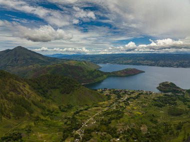 Aerial view of mountains with forest and Lake Toba. Samosir Island. Sumatra, Indonesia. clipart