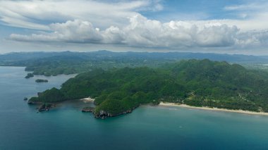 Aerial view of coast of the island with tropical vegetation and the beach. Negros, Philippines. clipart