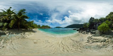 Sakin, tenha bir koy kristal berrak sular, palmiye ağaçları ve bulutlu gökyüzünün altında kayalık bir kıyı şeridi. Butzel Sahili. Mahe, Seyşeller. VR 360.
