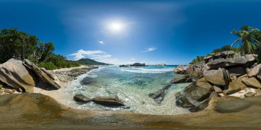 Jagged rocks meet crystal-clear waters under the bright sun, surrounded by tropical greenery and serene waves. La Digue, Seychelles. Virtual Reality 360. clipart