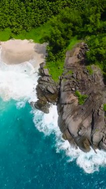 Rocky yarımadası yeşillikle kaplı, dalgaların çarptığı turkuaz okyanus sularıyla çevrili. Seyşeller, Mahe.