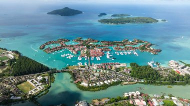 Eden Adaları 'nın teknelerle dolu limanlarının havadan görünüşü, parlak bir gökyüzünün altında berrak mavi sular. Seyşeller, Mahe.