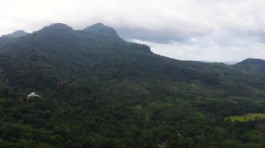 Top view of Mountain slopes with rainforest and agricultural land of farmers. Sri Lanka.