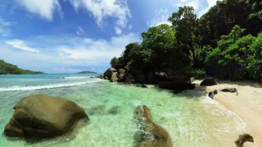 Turkuaz lagünü, kayalık oluşumları ve yemyeşil bitki örtüsü olan tenha bir tropikal plaj. Seyşeller, Mahe.