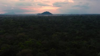 Top view of Sunset over the jungle on the background of mountains in the national park of Sri Lanka.