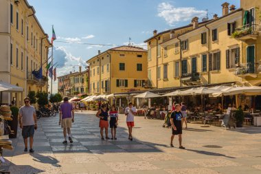Lazise, Italy - August 12, 2019: Main square in Lazise village, Piazza Vittorio Emanuele. Famous tourist place  at Lake Garda