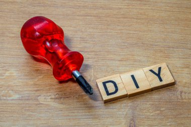 Metin tahta blokları tahta arkaplan üzerinde bir tornavida ile metin diy yazılıyor