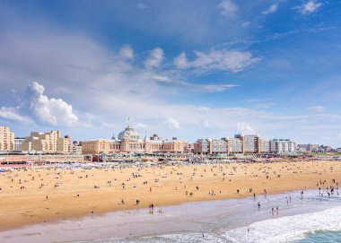 Scheveningen, Hollanda - 9 Haziran 2019: Güzel bir yaz günü iskeleden görülen Scheveningen plajı pek çok insan sahilde yürüyüş yapar.