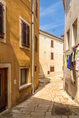 Vrsar, Croatia - July 25 2024: Narrow street in the old town of Vrsar, Croatian. The laundry hangs outside in the narrow streets of the village 