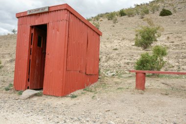 Otago Yeni Zelanda - 3 Mart 2010; Kızıl Cüce Kulübesi Merkez Otago Demiryolu 'ndaki küçük kıvrımlı demir kulübe