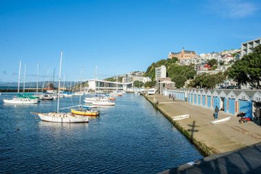 Wellington New Zealand - October 3 2010; Oriental Bay boat sheds and waterfront.with historic St Gerard's Monastery on skyline.