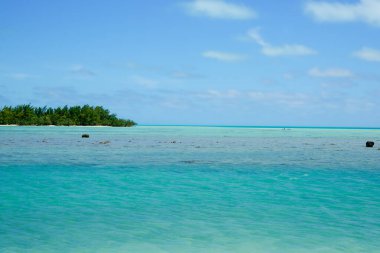 Ocean view to tropical South Pacific island on horizon