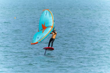 Tauranga New Zealand - March 8 2023; Wing-foiling across Pilot Bay in GWA tour event clipart