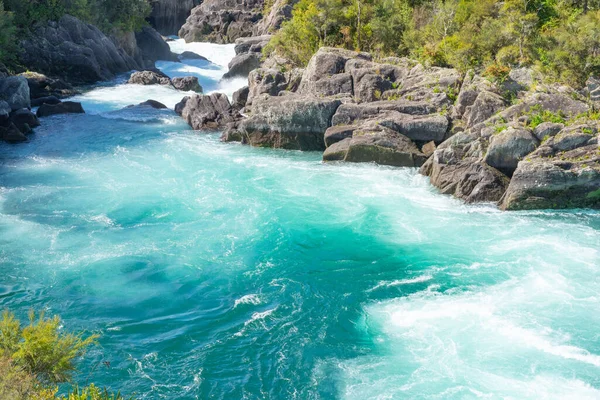 Swirling and surging white water of Waikato River through rocky ravine at Aratiatia.