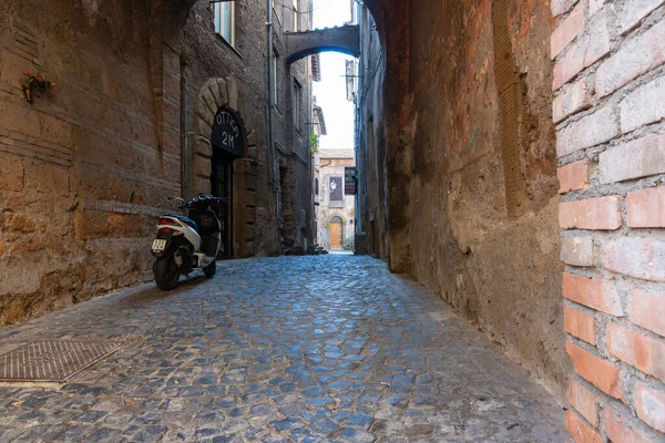 stock image Sutri Italy -  April 17 2011; moped parked in narrow cobblestone alleyway in typical ancient Italian town.