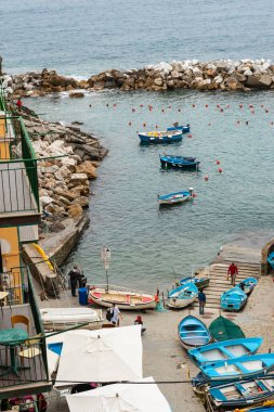 Riomaggiore İtalya - 24 Nisan 2011; Balıkçı tekneleri ve insanlı Cinque Terre Körfezi manzarası.