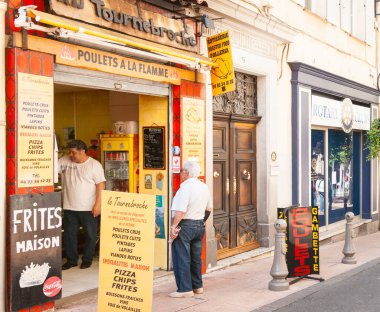 Antibes France - 1 Mayıs 2011; Dışarıdaki müşteri Antik Fransız şehrinde pişirilmiş tavuk yemeği mağazası.
