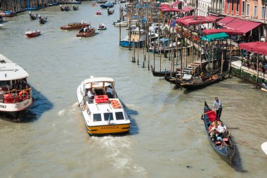 Venice Italy - May 10 2011;  Views of people and boating activity on Grand Canal from Rialto Bridge with boat named America.