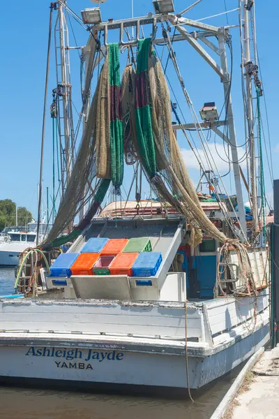 stock image Yamba Australia - February 10 2012; Prawn nets hanging from rigging above blue, orange and green plastic bins on Ashleigh Jayde.