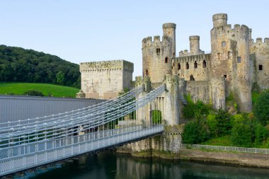 Three famous bridges across Conwy River enter medieval Castle. clipart