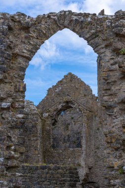 Pembroke Wales - 3 Ağustos 2024; Pembroke Kalesi içinde mavi gökyüzü ile dikey görüntü kemerleri.