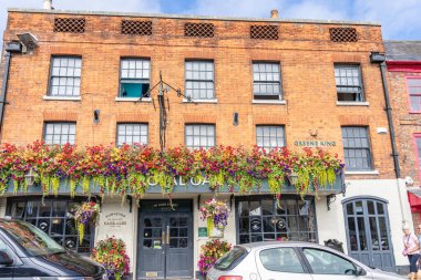 Marlborough United Kingdom- August 11 2024; Historic architecture of buildings along city High Street busy with tourists on sunny day. clipart