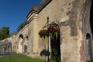 Chippenham United Kingdom - August 9 2024:  Historic Railway Viaduct with road leading through and showing original brick through plastered coating. clipart