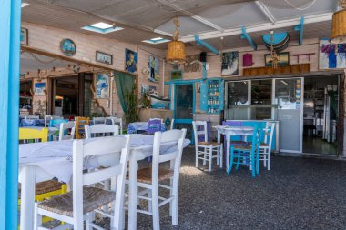 Kos Yunanistan - 25 Ağustos 2024; Mastihari 'deki Yunan plaj temalı restoranda beyaz ve mavi masalar ve sandalyeler.