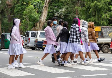 Nuwara Eliya Sri Lanka - 6 Eylül 2024; Bir grup genç kız öğrenci, maske takarak yaya geçidinde yürüyorlar..