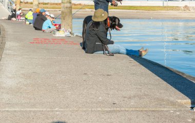 Tauranga Yeni Zelanda - 22 Nisan 2012; Bridge Marina 'da köpekle balık tutmak. 2012; Bridge Marina 'da köpekle balık avı.