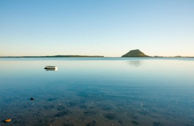 Sakin Tauranga liman manzaralı ufukta Maunganui Dağı görünüyor..