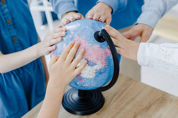 Touching Earth Globe Group Children Different Ages Stand Spacious Classroom — Stock fotografie