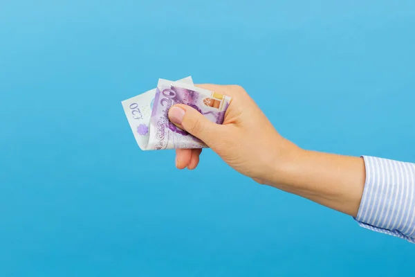 Woman Hand Holding Twenty British Pounds Banknote Isolated Blue Background — Stock Fotó