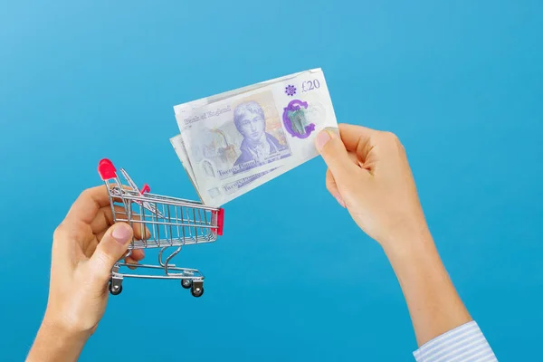 Woman Hand Puts British Pounds Shopping Cart Concept Saving Stores — Stock Fotó