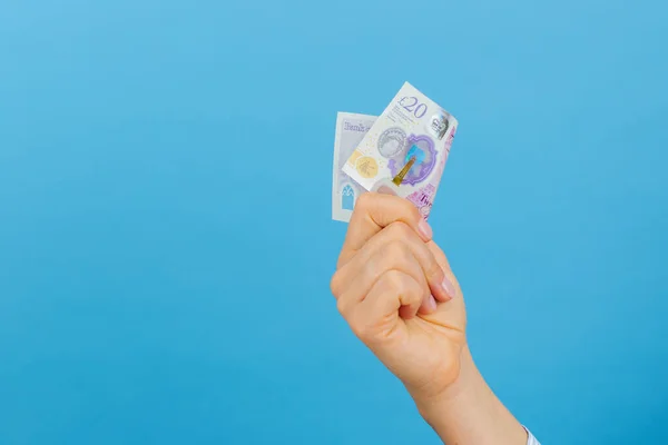 Woman Hand Holding Twenty British Pounds Banknote Isolated Blue Background — Stock Fotó