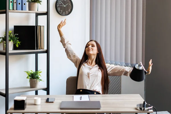 Smart business woman in formal suit outfit sitting and stretch relax in front of computer with happy and smile in modern office workplace. Young businesswoman relaxing in office.