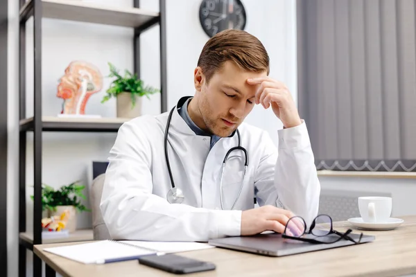 Handsome Doctor Man Wearing Medical Uniform Sitting His Workplace Tired — Foto Stock