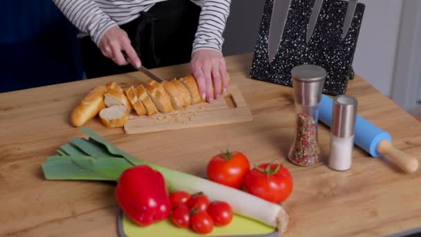 Young Happy Woman Slicing Baguette While Preparing Food Kitchen — Vídeo de Stock