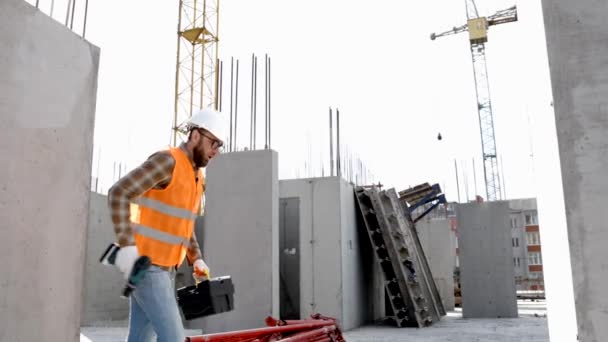 有趣的建筑工人跳舞 戴着头盔的建筑商们跳着积极的舞 身穿建筑工人制服的建筑工程师在他的工作场所跳舞 — 图库视频影像