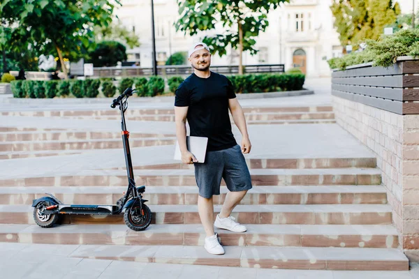 Handsome Man Holding Laptop His Hand Standing Electric Scooter Active — 图库照片