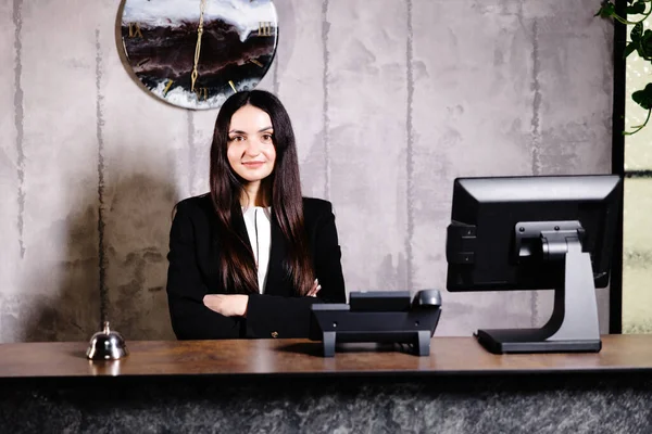 Portrait of receptionist at desk in lobby. Banner design. Friendly concierge at hotel reception behind the counter