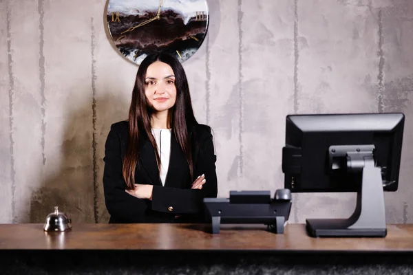 Portrait of receptionist at desk in lobby. Banner design. Friendly concierge at hotel reception behind the counter