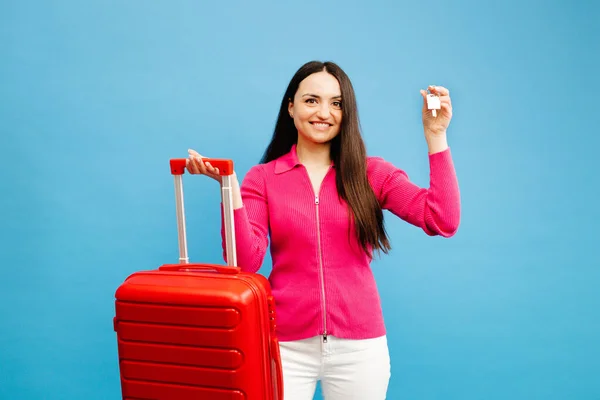 Young Woman Holding Suitcase Showing Keys Isolated Blue Background — Stock Photo, Image