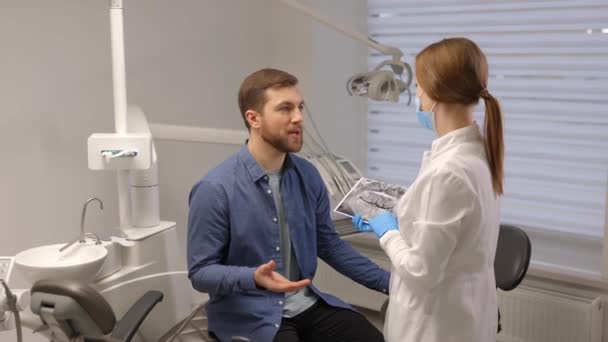Young Attractive Man Visiting Dentist Sitting Dental Chair Modern Light — Stock Video